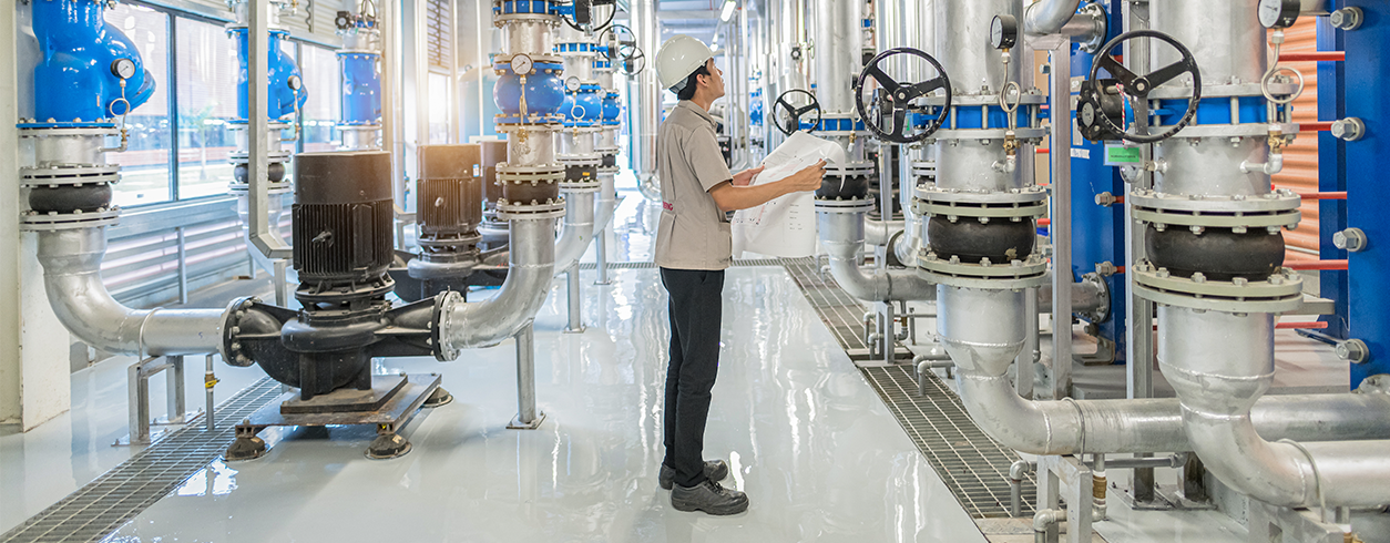 Man Inspecting Hydronic Equipment and Tech shutterstock_1741929506